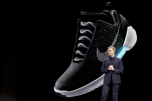 An image of the Nike HyperAdapt 1.0 is projected on a screen as Nike CEO Mark Parker speaks during a news conference, Wednesday, March 16, 2016, in New York. (AP Photo/Mary Altaffer)