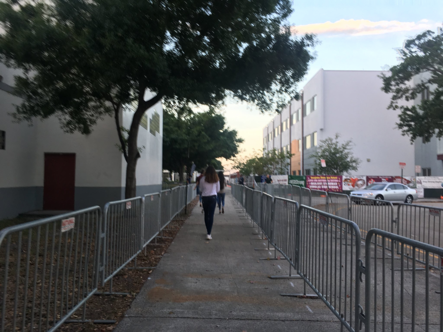 Stoneman Douglas senior Delaney Tarr walks into school on her first day back after a gunman killed 17 people at her school. This photo was shared by Tarr on her Twitter. Her tweet read, Nothing beats a morning walk throug fenced lines with a bag check! Where am I again?