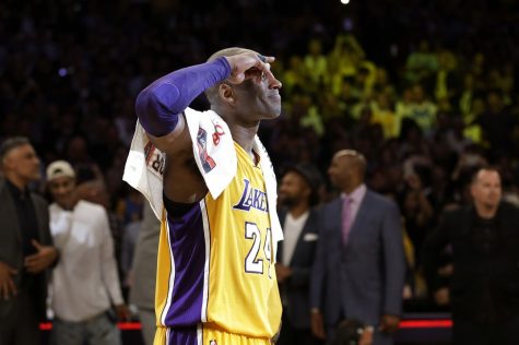 Kobe Bryant salutes to the fans at Staples Center after the last NBA basketball game in his career.  Bryant finished with 60 points in a 101-96 win over the Utah Jazz.