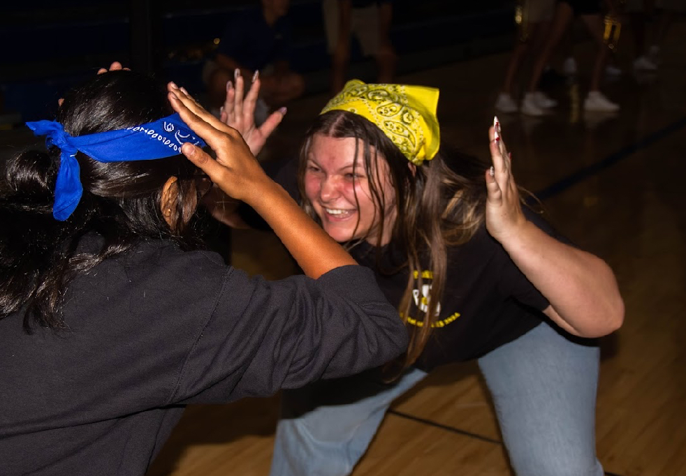 Senior Sydney J. takes on junior Tiya K in the kick-off rally game. The students played hand, knees, cup. 