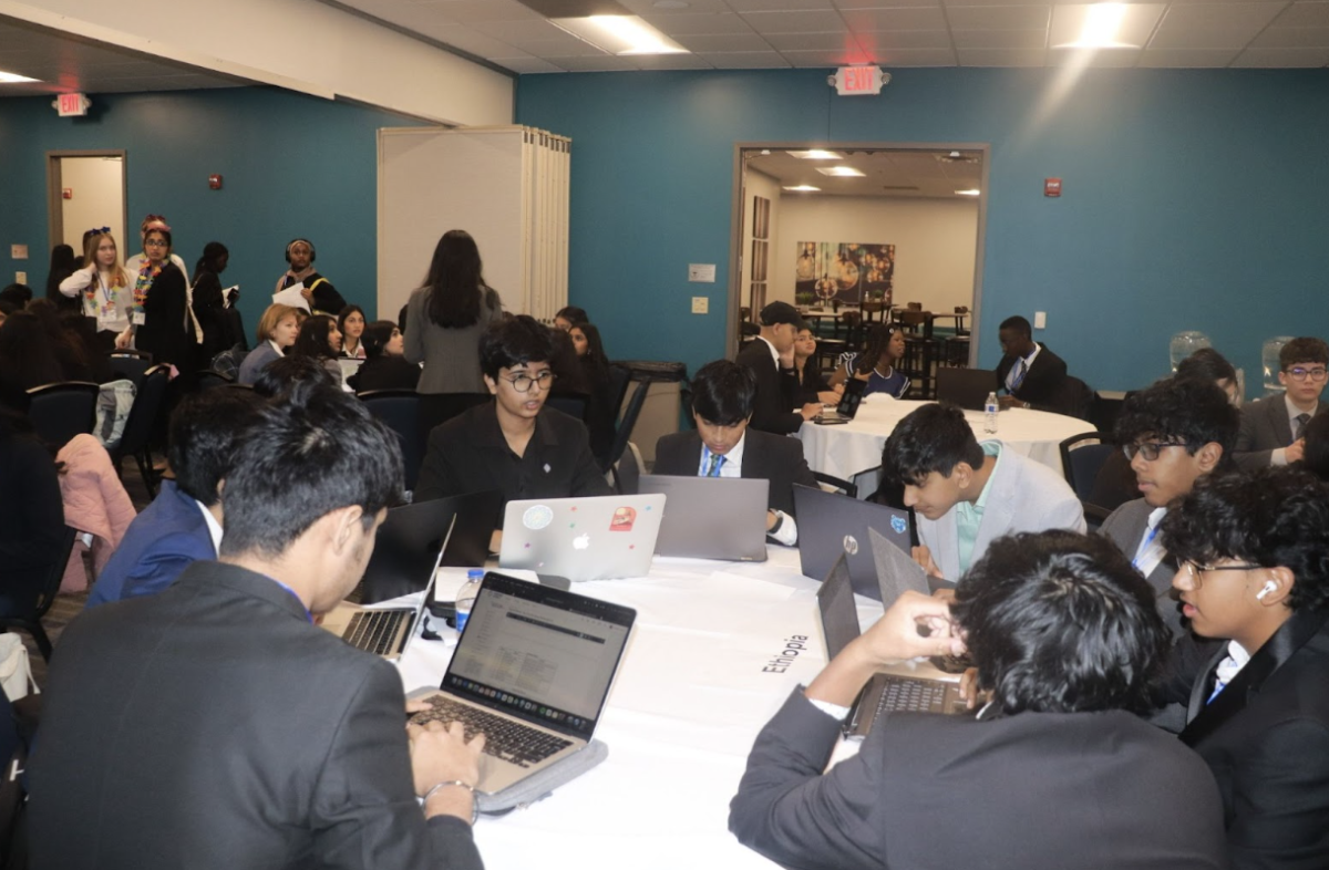 Members of Model UN work on Crisis together during the summit. Crisis is a designated block of time where delegates get the chance to work with other countries to solve an important issue. 