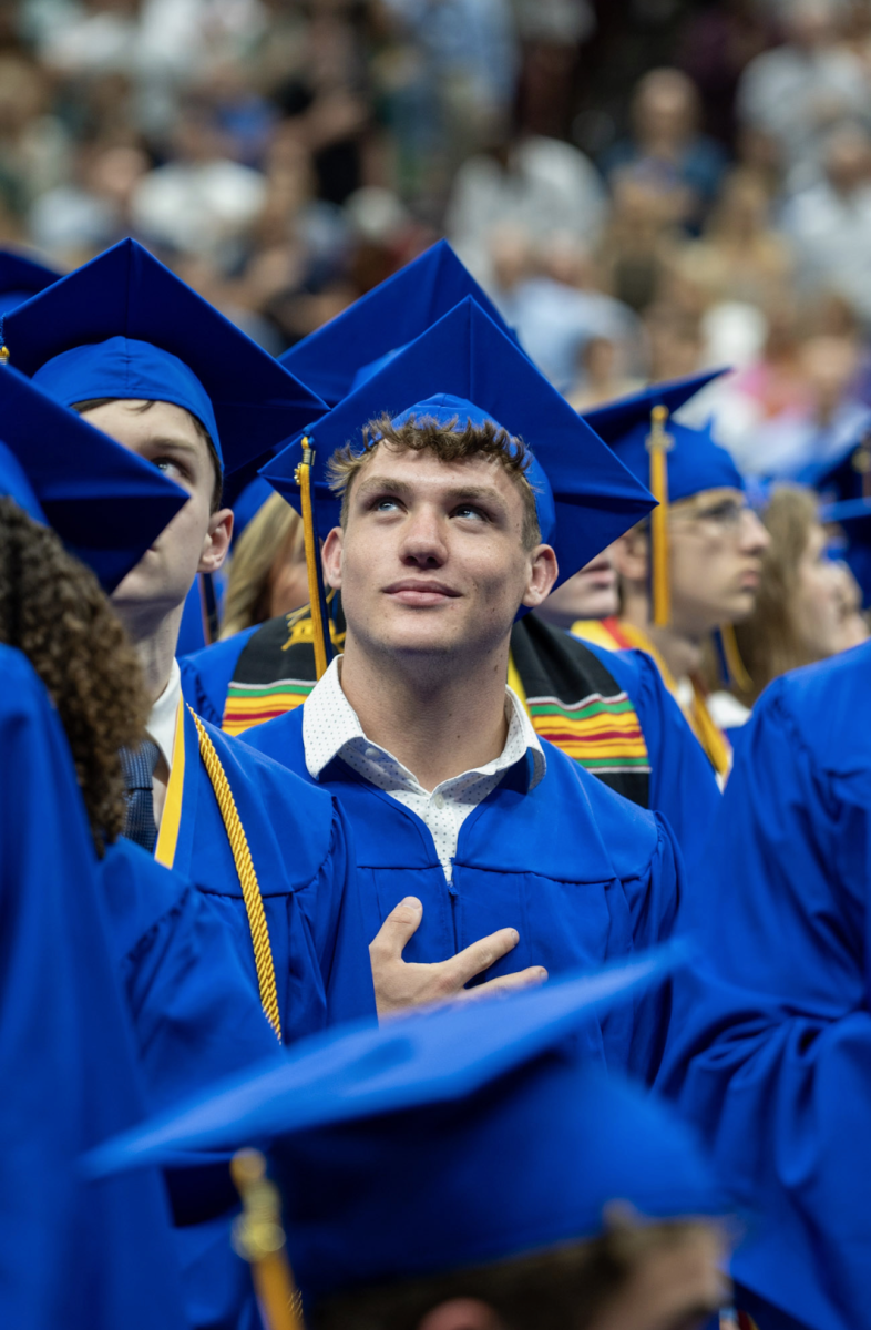 Former Braves football player Riley Grizlak stands for the national anthem at the class of 2025 graduation ceremony. After an impressive senior year, Grizlak took in the moment. 

