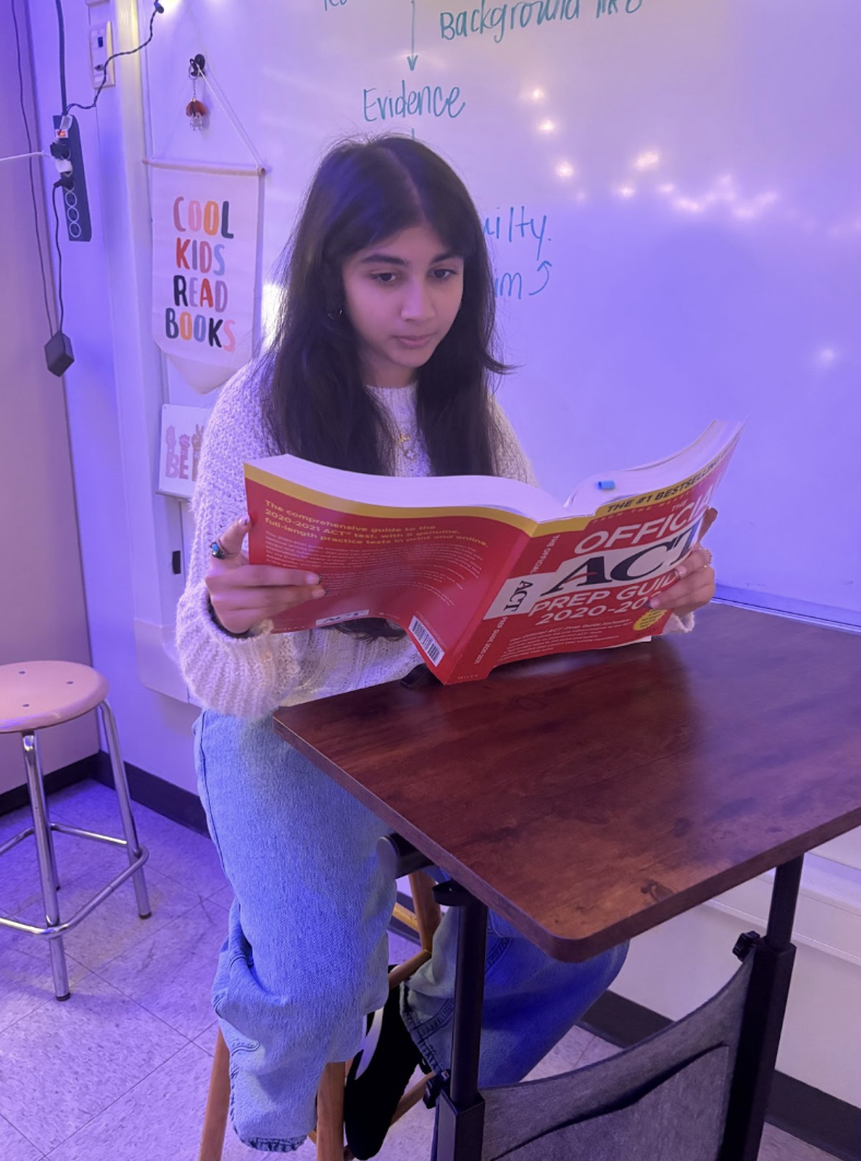 Maira Munshi, sophomore, studying the ACT book shown on the left.