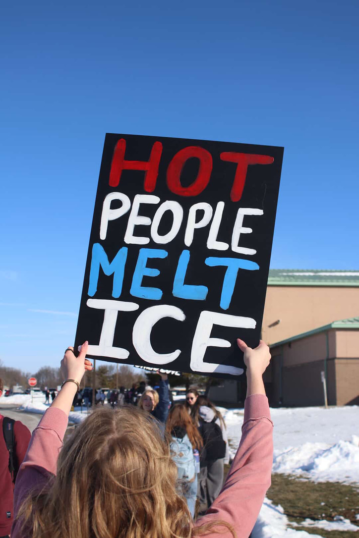 Student holds sign in protest of ICE. Students spent the week to make posters.